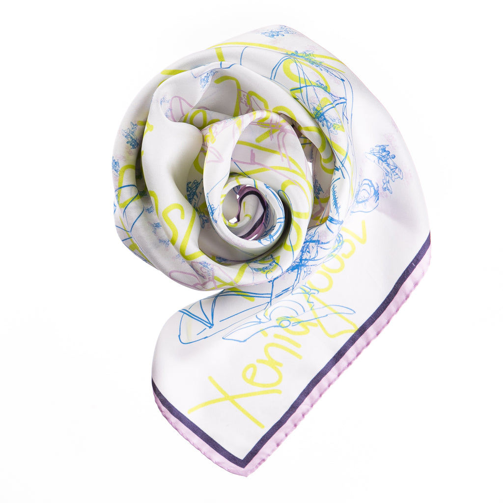 ABOVE THE SKY silk scarf by Xenia Joost in white, pink, blue and lemon yellow, folded into a sculptural rose shape