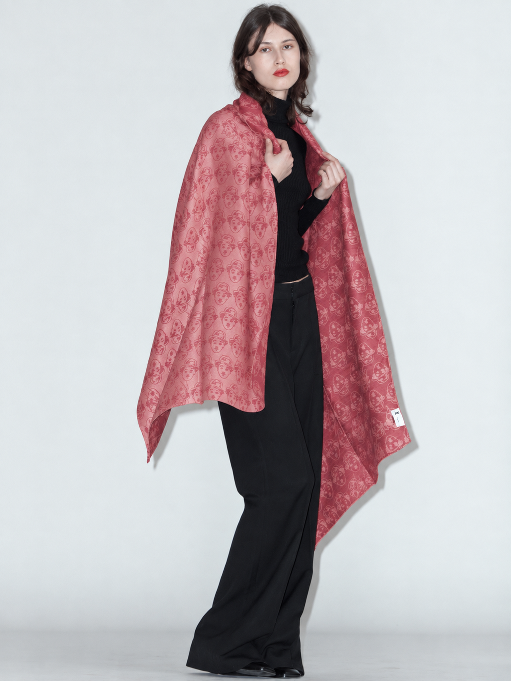 CHARLIE wool and silk scarf in red, worn draped over the shoulders