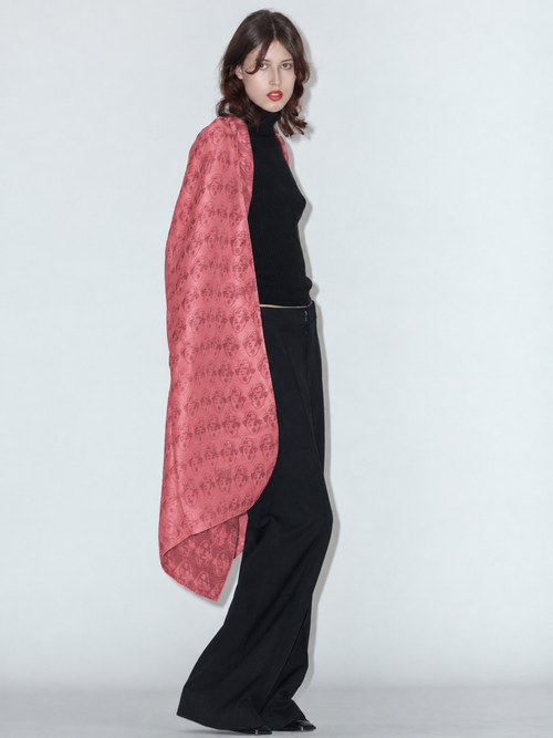 CHARLIE wool and silk scarf in red, worn draped over the shoulders