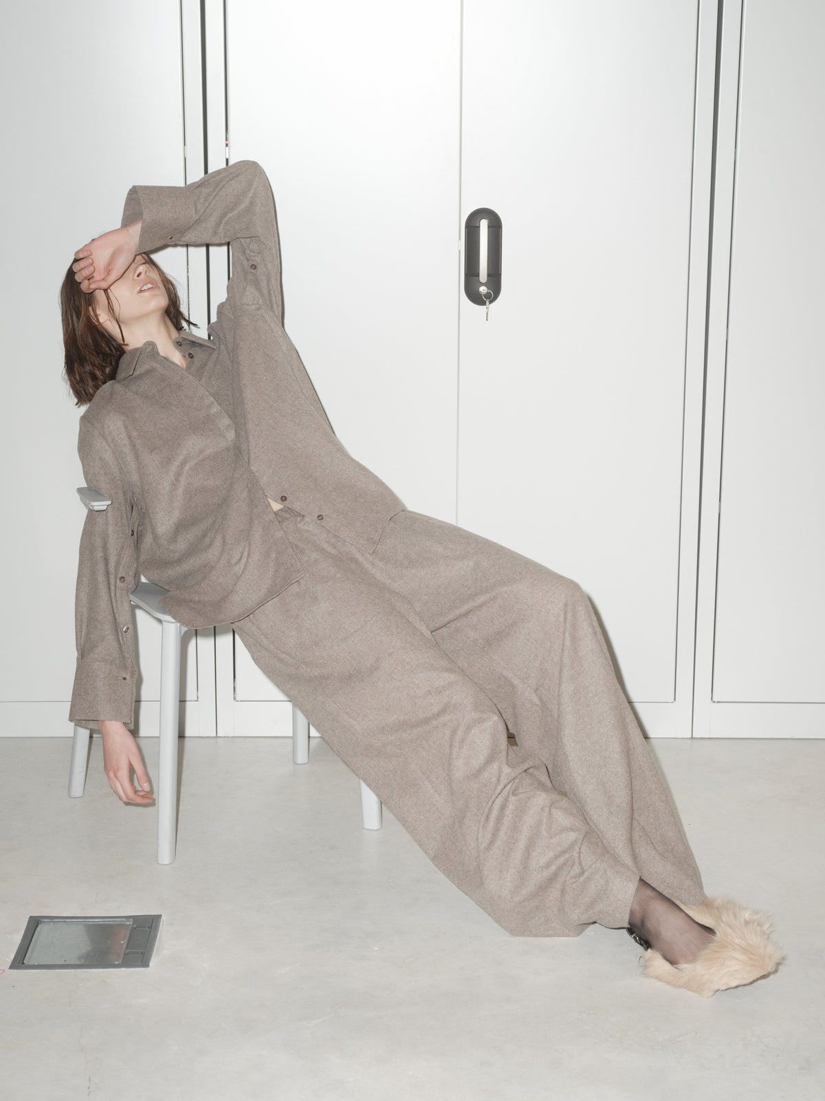 THE STATEMENT SHIRT — Sleeve It Down 003 in beige wool, seated editorial view with matching trousers