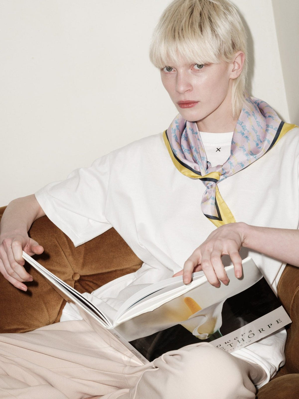 FLY HIGH silk scarf by Xenia Joost worn around the neck, editorial