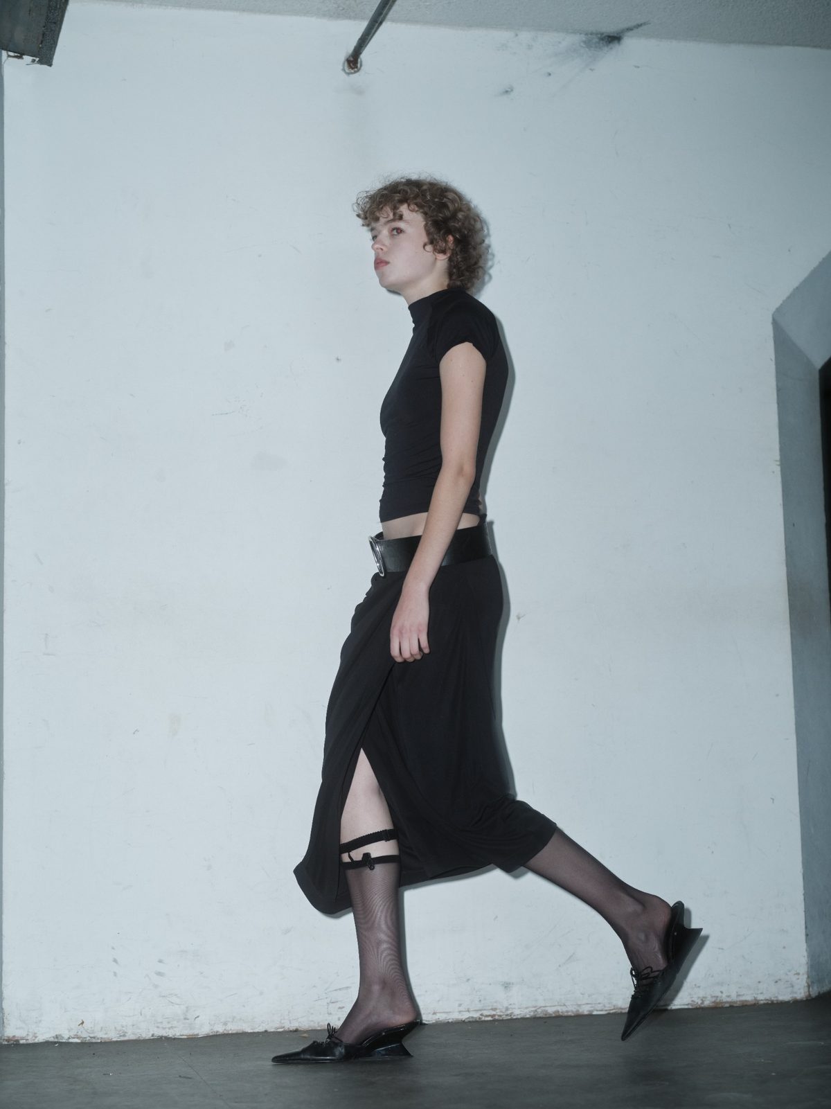 MUSTIQUE draped black skirt by Xenia Joost in movement, showing the side slit