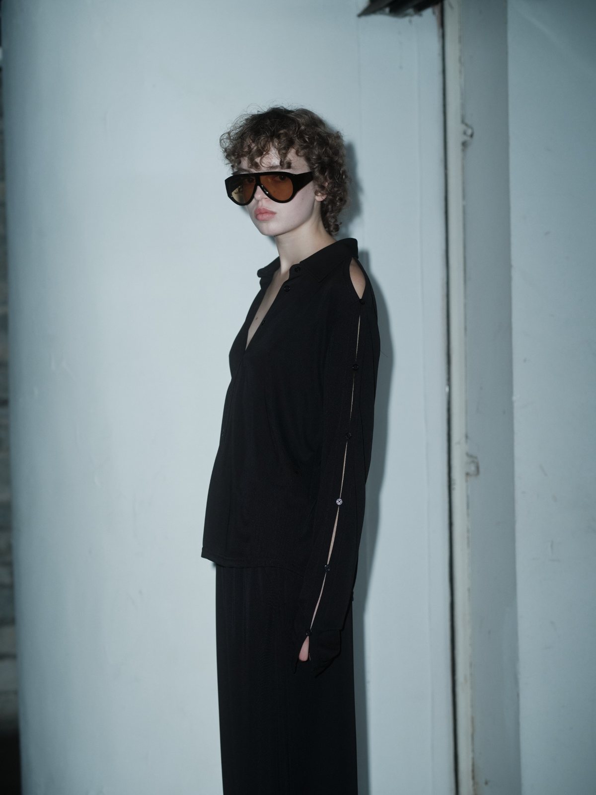 SLEEK VENTURA top in black by Xenia Joost, side view, sleeve detail