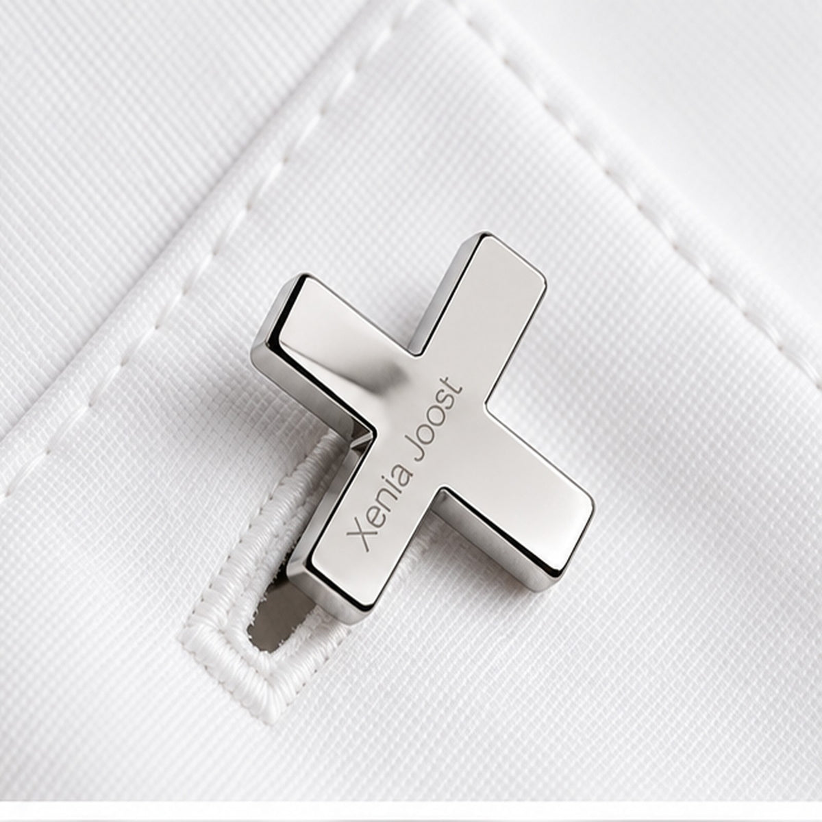 X cufflinks by Xenia Joost in polished silver finish worn on a white shirt cuff