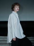Xenia Joost The Statement Shirt — Button Down 001 in white, showing the oversized silhouette and buttoned sleeve construction.