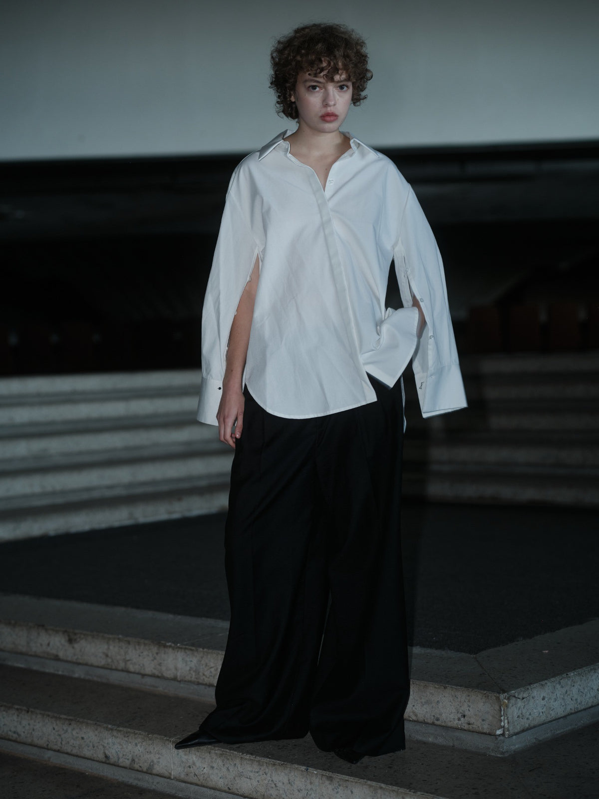 Xenia Joost The Statement Shirt — Button Down 001 in white, worn with both sleeves buttoned open.